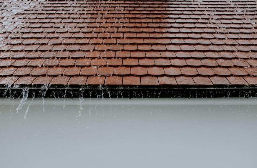 rain cascading down the edge of a roof